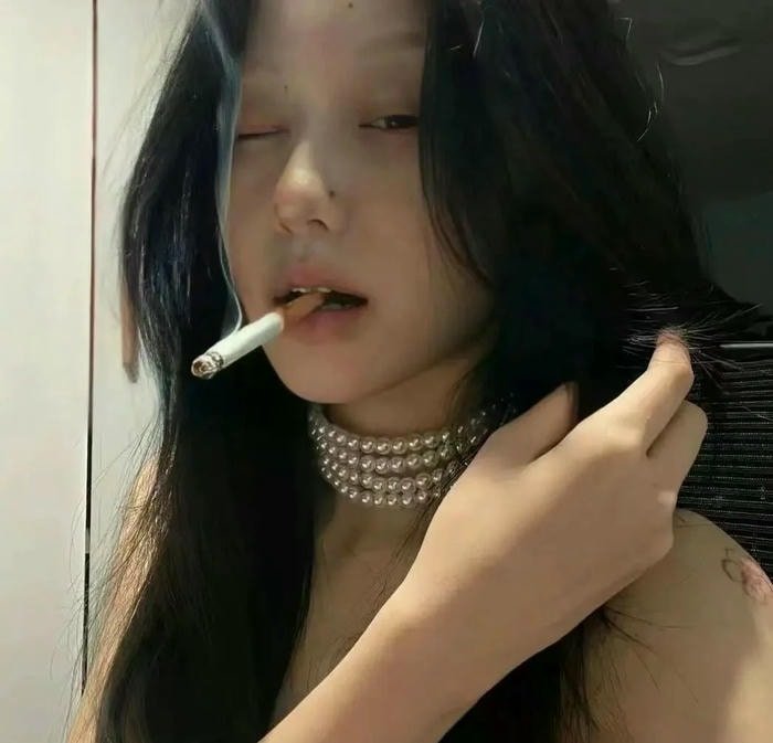 aesthetic smoking girl dp under soft lighting.