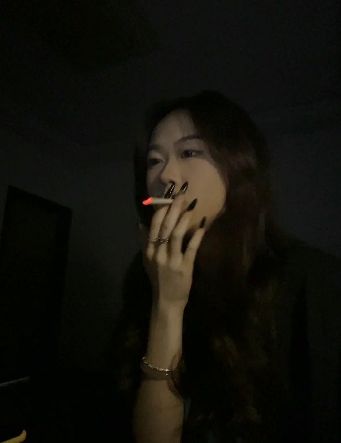 cool aesthetic smoking girl dp with warm tone.
